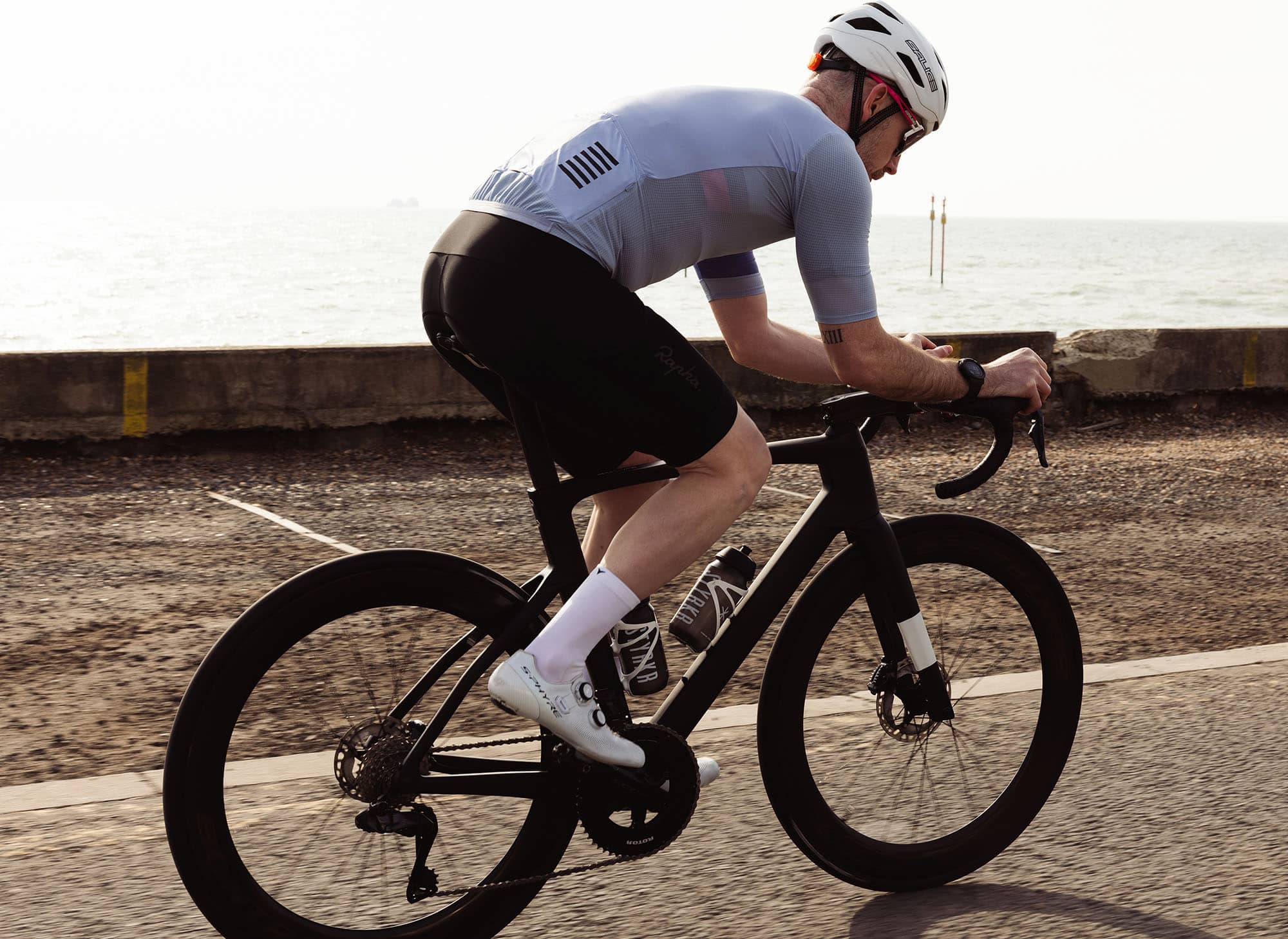 Male cyclist wearing Veto men's cycling socks on a road bike 